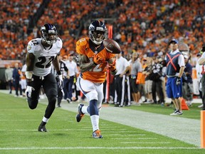 DENVER, CO - SEPTEMBER 5: Andre Caldwell #12 of the Denver Broncos catches a 28-yard pass before running in for the touchdown in front of Jimmy Smith #22 of the Baltimore Ravens in the third quarter during the game at Sports Authority Field at Mile High on September 5, 2013 in Denver Colorado. (Photo by Dustin Bradford/Getty Images)