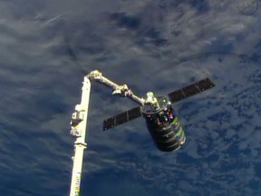 This framegrabbed image provided by NASA-TV shows the Cygnus spacecraft attached to the Canadarm 2 on the International Space Station Sunday Sept. 29, 2013.