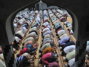 Pakistani Muslims offer Friday prayers at a mosque during the month of Ramadan in Lahore on July 26, 2013.