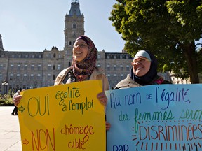 The Parti Québécois government appears to be digging in its heels for an extended debate on its controversial religion plan, having brushed off invitations for a speedy compromise. Two Muslim women demonstrate against the proposed Quebec charter of values Tuesday, September 17, 2013 at the legislature in Quebec City