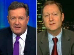 Piers Morgan in the midst of a heated argument with   his guest, John Lott, Monday night.
