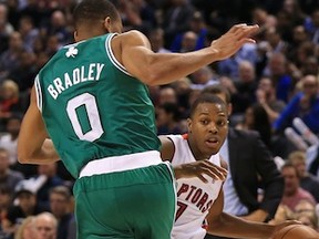 TORONTO, ON - OCTOBER 30:  Avery Bradley #0 of the Boston Celtics defends against Kyle Lowry #7 of the Toronto Raptors as he drives to the basket during their NBA game at the Air Canada Centre on October 30, 2013 in Saint John, New Brunswick, Canada.  NOTE TO USER: User expressly acknowledges and agrees that, by downloading and/or using this photograph, user is consenting to the terms and conditions of the Getty Images License Agreement.(Photo by Dave Sandford/Getty Images)