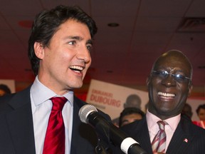 Liberal Leader Justin Trudeau, left, speaks to supporters alongside Emmanuel Dubourg in Montreal Monday, November 25, 2013 following Dubourg's win in the federal byelection for the riding of Bourassa. THE CANADIAN PRESS/Graham Hughes