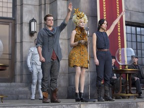 This image released by Lionsgate shows Josh Hutcherson as Peeta Mellark, from left, Elizabeth Banks as Effie Trinket and Jennifer Lawrence as Katniss Everdeen in a scene from "The Hunger Games: Catching Fire." (AP Photo/Lionsgate, Murray Close)
