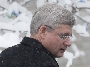 Canadian Prime Minister Stephen Harper makes his way to his car as he leaves his residence at 24 Sussex Drive, Wednesday, November 27, 2013 in Ottawa. THE CANADIAN PRESS/Adrian Wyld