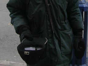 A man begs on a Toronto street.