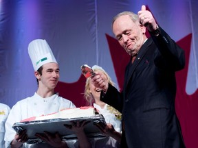 Jean Chretien gives the thumbs up after sampling the cake on his 80th birthday.