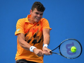 Canada's Milos Raonic plays a shot during his men's singles match against Romania's Victor Hanescu on day four of the 2014 Australian Open tennis tournament in Melbourne on January 16, 2014.
