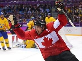 In this Feb. 23, 2014 file photo, Sidney Crosby celebrates after scoring against Sweden at the Sochi Olympics.