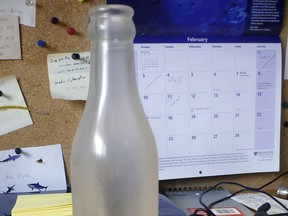 This January 2014 photo released by the Woods Hole Oceanographic Institution on Cape Cod, Massachusetts, shows a glass bottle that had contained a message from the institution, which was recovered on Sable Island, Nova Scotia, by biologist Warren N. Joyce of Canada's Department of Fisheries and Oceans. The bottle  was among thousands dumped in the Atlantic Ocean between 1956 and 1972 as part of a program by Woods Hole oceanographer Dean Bumpus to study surface and bottom currents. About 10 percent of the 300,000 drift bottles have been found over the years. (AP Photo/Warren N. Joyce)