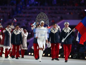 Bobsleigh racer Alexander Zubkov of the Russia Olympic team carries his country's flag during the Opening Ceremony of the Sochi 2014 Winter Olympics at Fisht Olympic Stadium on February 7, 2014 in Sochi, Russia.
