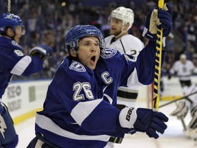 Tampa Bay Lightning right wing Martin St. Louis (26) celebrates after scoring against the Los Angeles Kings during the second period of an NHL hockey game Tuesday, Oct. 15, 2013, in Tampa, Fla. (AP Photo/Chris O'Meara)