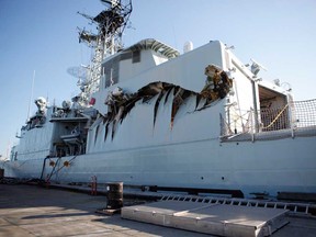 Royal Canadian Navy warship HMCS Algonquin sits in port with significant damage to her port side hangar at CFB Esquimalt in Esquimalt, B.C. Sunday September 1, 2013 following a collision with the HMCS Protecteur during a close-quarters training exercise.