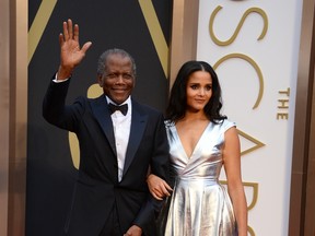 Sidney Poitier, left, and his daughter Sydney Tamiia Poitier arrive at the Oscars on Sunday, March 2, 2014, at the Dolby Theatre in Los Angeles.  (Photo by Jordan Strauss/Invision/AP)