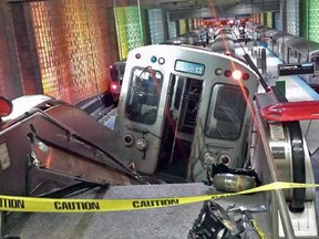 A Chicago Transit Authority train car rests on an escalator at the O'Hare Airport station after it derailed early Monday, March 24, 2014, in Chicago. More than 30 people were injured after the train "climbed over the last stop, jumped up on the sidewalk and then went up the stairs and escalator," according to Chicago Fire Commissioner Jose Santiago. (AP Photo/NBC Chicago, Kenneth Webster) MANDATORY CREDIT