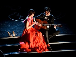HOLLYWOOD, CA - MARCH 02:  Singer Karen O and musician Ezra Koenig perform onstage during the Oscars at the Dolby Theatre on March 2, 2014 in Hollywood, California.  (Photo by Kevin Winter/Getty Images)