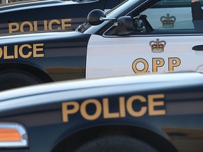 An Ontario Provincial Police officer sits in his cruiser Wednesday, Dec. 12, 2012, at the Tecumseh, Ont. detachment. For story on skyrocketing price of OPP. (DAN JANISSE/The Windsor Star) Photo Assignment ID: 00016981A ORG XMIT: POS1212121439267809