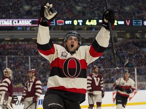 In this March 2, 2014 file photo, Ottawa Senators forward Clarke MacAthur celebrates after scoring against the Vancouver Canucks in the NHL Heritage Classic.