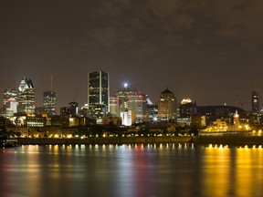 Buildings stand at night in the city skyline of Montreal, Quebec, Canada.