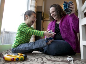 Local Input~ TORONTO, ONTARIO: April 22, 2014 - Katie McCreary plays with her son Xander MacMaster, 7, who has down syndrome at their Bowmanville, Ontario home Tuesday April 22, 2014. (Tim Fraser for Postmedia News)  (For n/a Line story by 0528-CNIB) ORG XMIT: POS1404231152483331