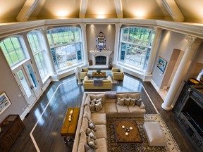 The living room boasts a vaulted 40-foot ceiling, inlaid wood floors and a wood-burning fireplace.