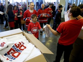 MONTREAL, QC - MAY 17:  Montreal Canadiens fans get flags as they enter before Game One of the Eastern Conference Finals of the 2014 NHL Stanley Cup Playoffs against the New York Rangers at the Bell Centre on May 17, 2014 in Montreal, Canada.  (Photo by Bruce Bennett/Getty Images)
