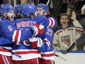 The New York Rangers celebrate after a second period goal by center Dominic Moore (28) against the Montreal Canadiens in Game 6 of the NHL hockey Stanley Cup playoffs Eastern Conference finals, Thursday, May 29, 2014, in New York. (AP Photo/Kathy Willens)