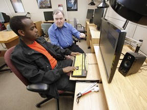 Getachew Addgeh, left, works on screen reader technology JAWS with Peter Pankhurst, a CNIB specialist in assistive technology.