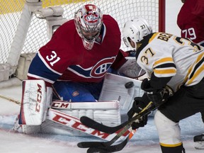 Montreal Canadiens goaltender Carey Price makes a save as Boston Bruins' Patrice Bergeron looks for the rebound during first period NHL playoff hockey action Thursday, May 8, 2014 in Montreal. THE CANADIAN PRESS/Paul Chiasson