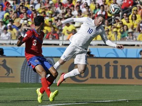 England's Wayne Rooney reaches to head the ball during the group D World Cup soccer match between Costa Rica and England at the Mineirao Stadium in Belo Horizonte, Brazil, Tuesday, June 24, 2014. (AP Photo/Matt Dunham)