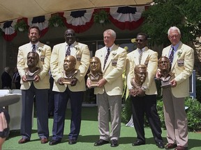 FILE - In this July 31, 1993, file photo, the 1993 class of inductees poses with their busts in front of the Pro Football Hall of Fame in Canton, Ohio. From left are Dan Fouts, Larry Little, Chuck Noll, Walter and Bill Walsh. Noll, the Hall of Fame coach who won a record four Super Bowl titles with the Pittsburgh Steelers, died Friday night, June 13, 2014, at his home. He was 82. The Allegheny County (Pa.) Medical Examiner said Noll died of natural causes. (AP Photo/Bruce Zake, File)