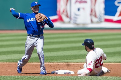 Ryan Goins counsels grounds crew on new dirt infield at the Rogers Centre -  The Globe and Mail