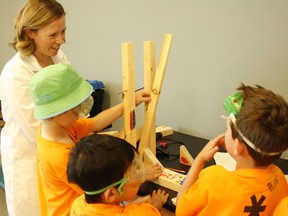 Beakerhead’s Katie Varney with TELUS Spark Science Centre camp participants and their newly built catapult.