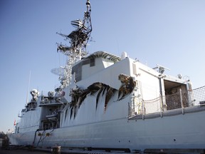 Royal Canadian Navy warship HMCS Algonquin sits in port with significant damage to her port side hangar at CFB Esquimalt in Esquimalt,B.C. Sunday September 1, 2013 following a collision with the HMCS Protecteur during a close-quarters training exercise.