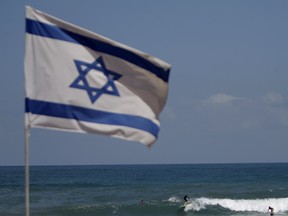 An Israeli flag flies on a beach in Tel Aviv.