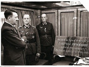 Adolf Hitler examines the plaque commemorating Gavrilo Princip's assassination of Archduke Franz Ferdinand, which was removed from Sarajevo by German troops and presented to him on his 52nd. birthday in 1941. The photograph was taken by Hitler’s personal photographer, Heinrich Hoffmann.