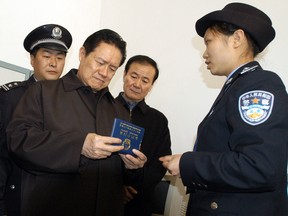 This photo taken on January 31, 2006 shows China's former security chief Zhou Yongkang (C) visiting grassroot police officers in Guiyang, in southwest China's Guizhou province.