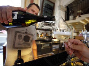A bartender pours Prosecco wine into a glass for an Italian oenologist to test for authenticity at a restaurant in Treviso, Italy, on Tuesday, Sept. 3, 2013.