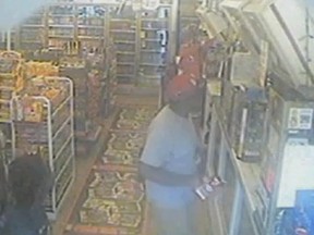 A still from a surveillance video which police say shows Michael Brown stealing a $8.99 box of cigarellos shortly before his death.