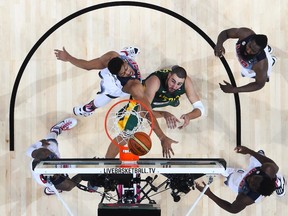 BARCELONA, SPAIN - SEPTEMBER 11:  Jonas Valanciunas #14 of the Lithuania Basketball Men's National Team fightrs for the ball against USA Basketball Men's National Team during a 2014 FIBA Basketball World Cup semi-final match between USA and Lithuania at Palau Sant Jordi on September 11, 2014 in Barcelona, Spain.  (Photo by David Ramos/Getty Images)