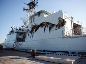 HMCS Algonquin sits in port with significant damage to her port side hangar at CFB Esquimalt, B.C. on September 1, 2013 following a collision with the HMCS Protecteur. She's now one of four retired veteran ships.