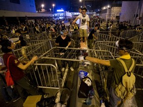 Youthful protesters erect barriers in Hong Kong.