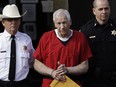 In this Oct. 9, 2012 file photo, former Penn State University assistant football coach Jerry Sandusky, centre, is taken from the Centre County Courthouse after being sentenced in Bellefonte, Pa.