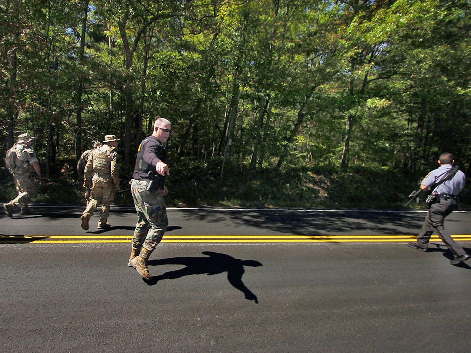 Pennsylvania police shooting suspect's SUV found partially submerged in