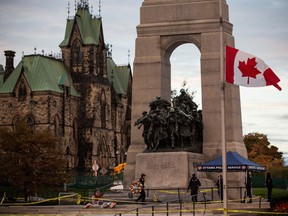 A flag flies at half-staff at the National War Memorial, where Cpl. Nathan Cirillo of the Canadian Army Reserves was killed yesterday while standing guard by a lone gunman, on October 23, 2014 in Ottawa, Canada. After killing Cirillo the gunman stormed the main parliament building, terrorizing the public and politicians, before he was shot dead.