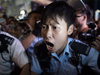 A policewoman shouts at pro-democracy protesters to back off as they try to arrest a protester setting up a barricade in the Mongkok district of Hong Kong.