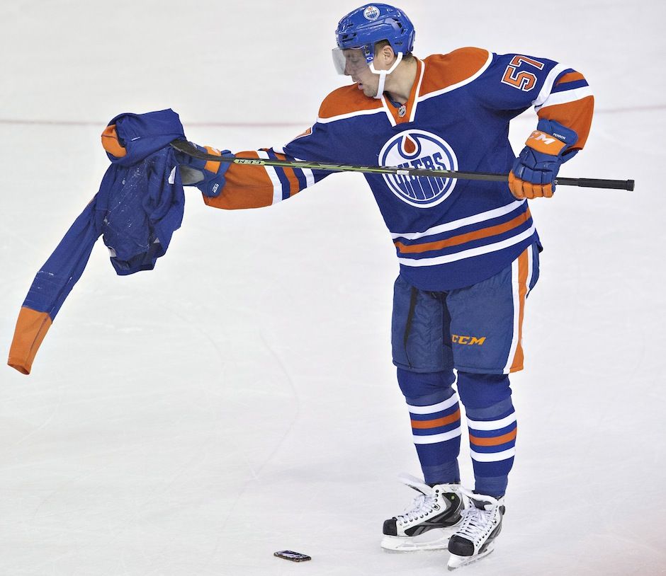 Oilers fan throws store jersey on ice