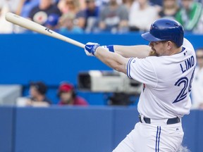 Toronto Blue Jays Adam Lind hits a two run double off Chicago White Sox pitcher Scott Carroll during first inning baseball action in Toronto on Thursday June 26 , 2014. THE CANADIAN PRESS/Chris Young