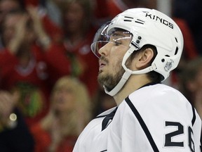 FILE - In this May 18, 2014, file photo, Los Angeles Kings' Slava Voynov reacts  during the second period in Game 1 of the Western Conference finals in the NHL hockey Stanley Cup playoffs in Chicago. Voynov has been charged with felony domestic violence. The Los Angeles County district attorneyís office announced the charge Thursday, Nov. 20, 2014. Voynov faces one felony count of corporal injury to a spouse with great bodily injury. The district attorneyís office says Voynov ìcaused his wife to suffer injuries to her eyebrow, cheek and neckî during an argument. (AP Photo/Nam Y. Huh, File)