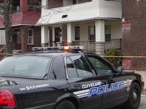 A police car is parked before the residence of 50-year-old convicted rapist and alleged serial killer Anthony Sowell on November 4, 2009 in Cleveland, Ohio. A US judge on Noveber 4, 2009 charged Sowell with five counts of murder and refused him bail as investigators examined the gruesome remains of up to 11 victims found at his Cleveland home. "This is without question the most serious set of allegations I've been exposed to," said judge Ronald Adrine, refusing bail due to the macabre nature of the crimes and defendant Anthony Sowell's past criminal history.   AFP PHOTO / Stefan HLABSE (Photo credit should read STEFAN HLABSE/AFP/Getty Images)